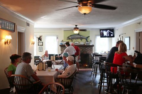 Guests gather for lunch at the bar and dining room of Tarpon Lodge.