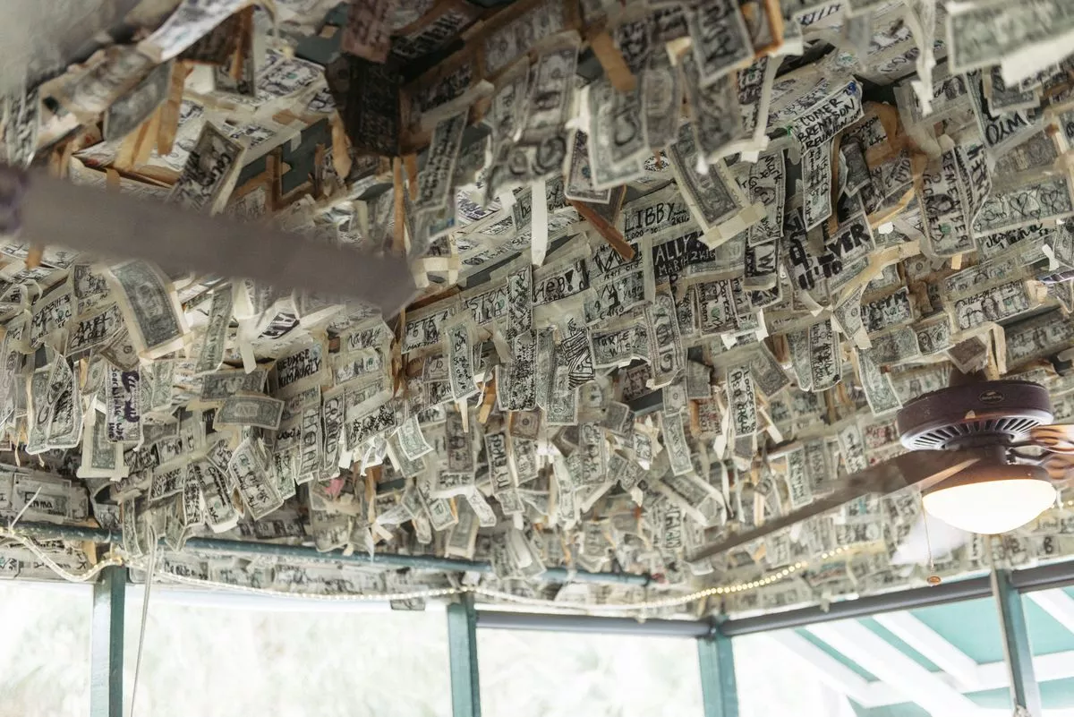 Dollar bills hanging from the ceiling at cabbage key restaurant.