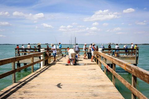 Looking down the pier at people fishing on Sanibel Island